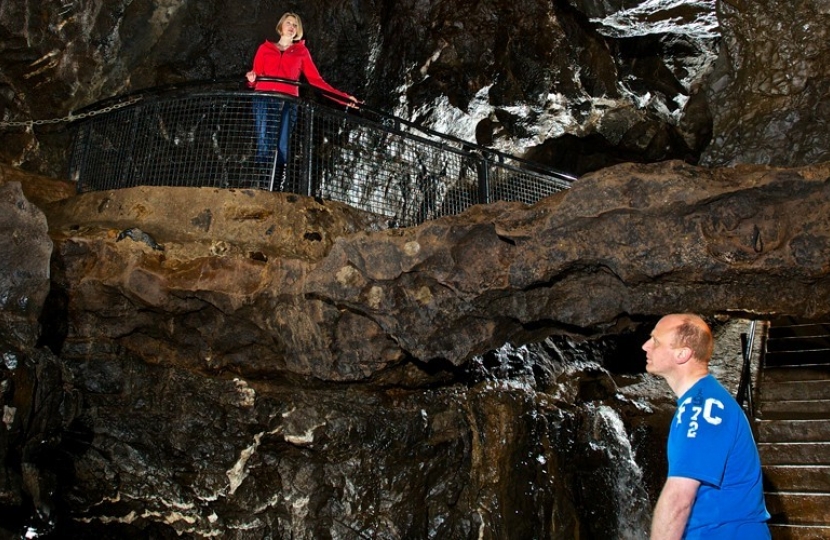 Two people stand more than two metres apart in Dan-yr-Ogof Caves